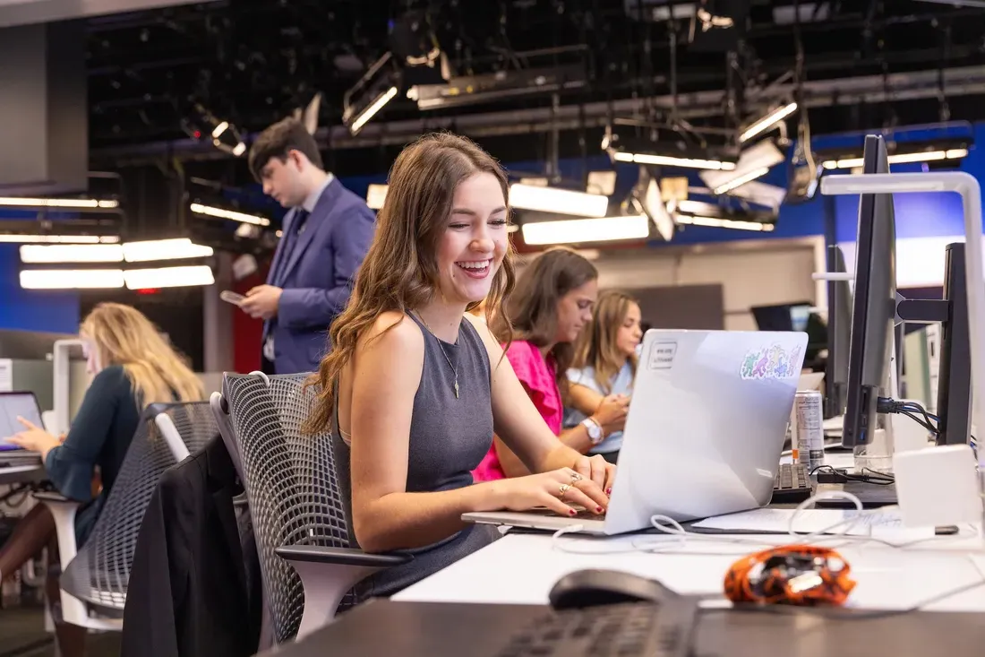 Student sitting at a desk working on her computer.